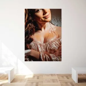 Photo artistique d'une femme avec un sourire subtil, portant une robe brillante rose, montrant des détails de peau et de texture de tissu.